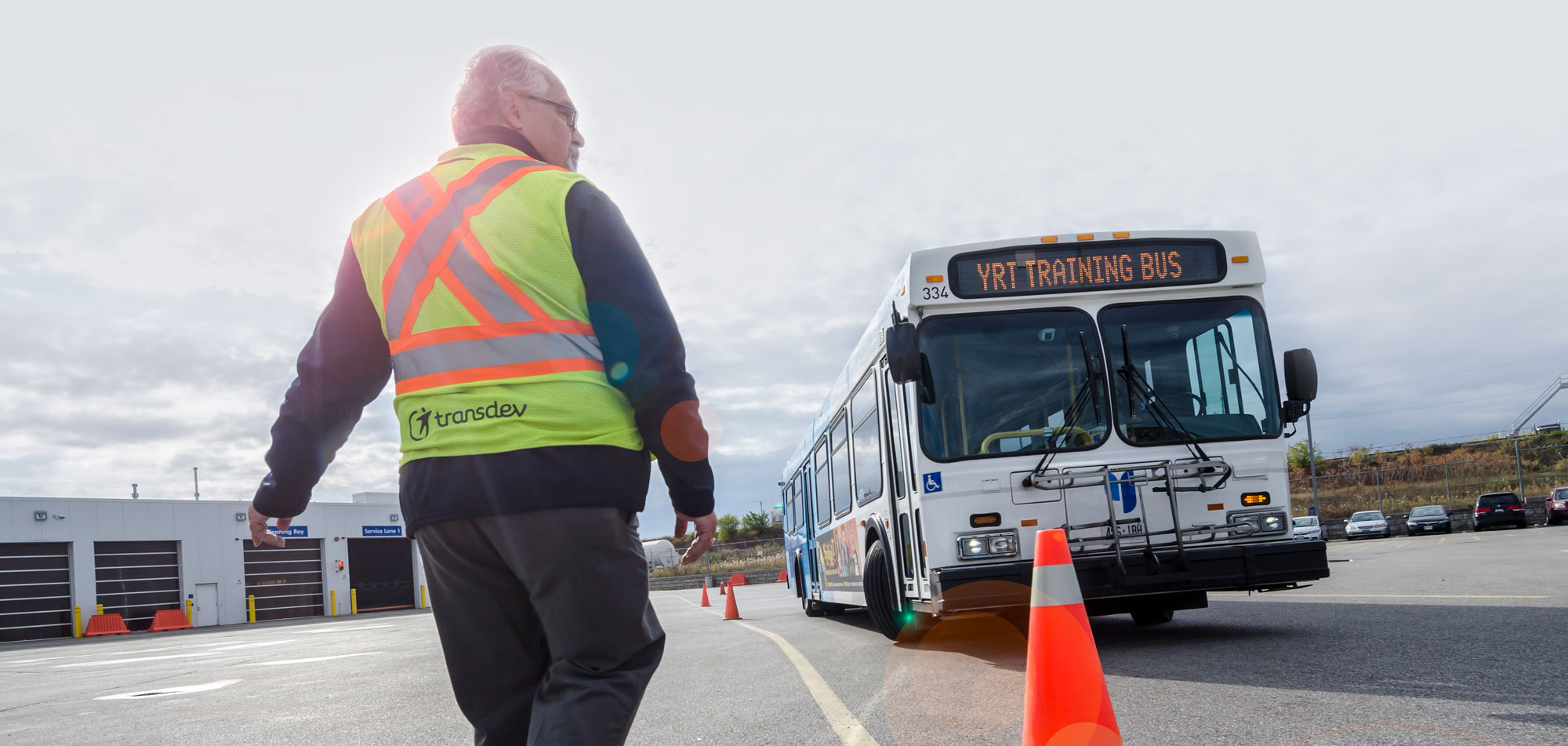 Safety Employee checking safety cones near bus in preparation for a day of travel